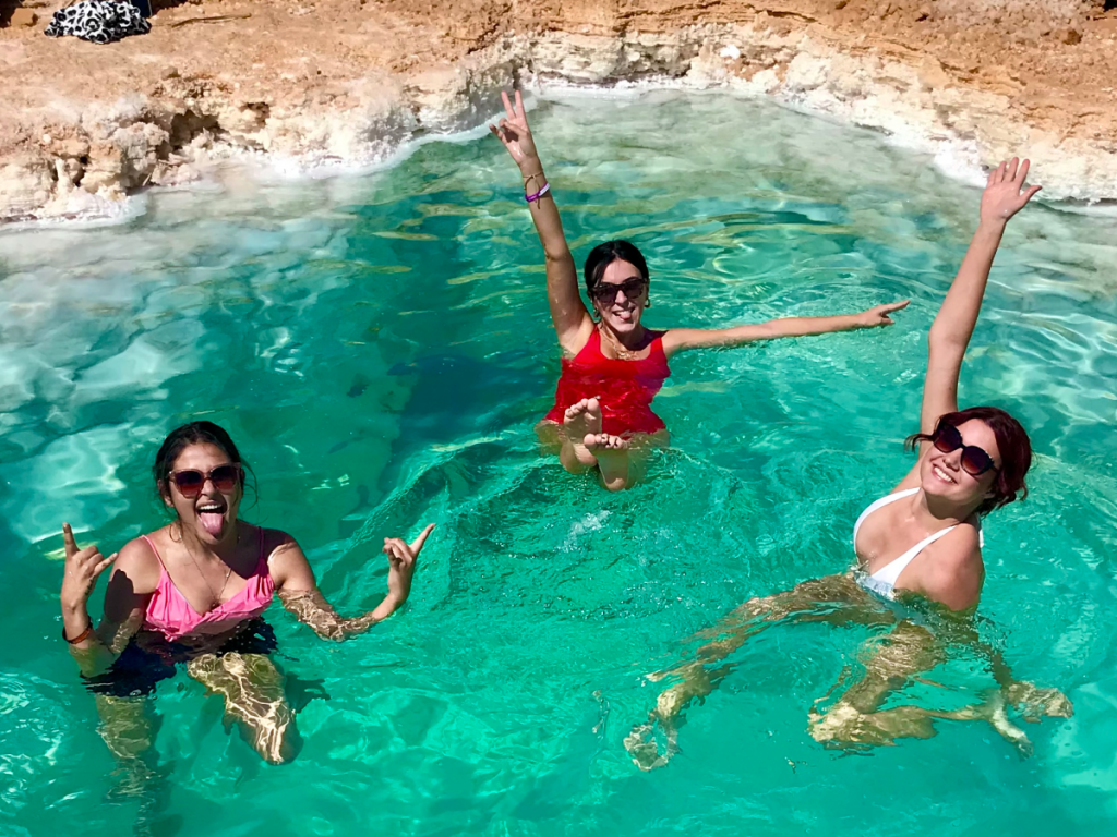 Three girls floating in the salt lakes of Siwa